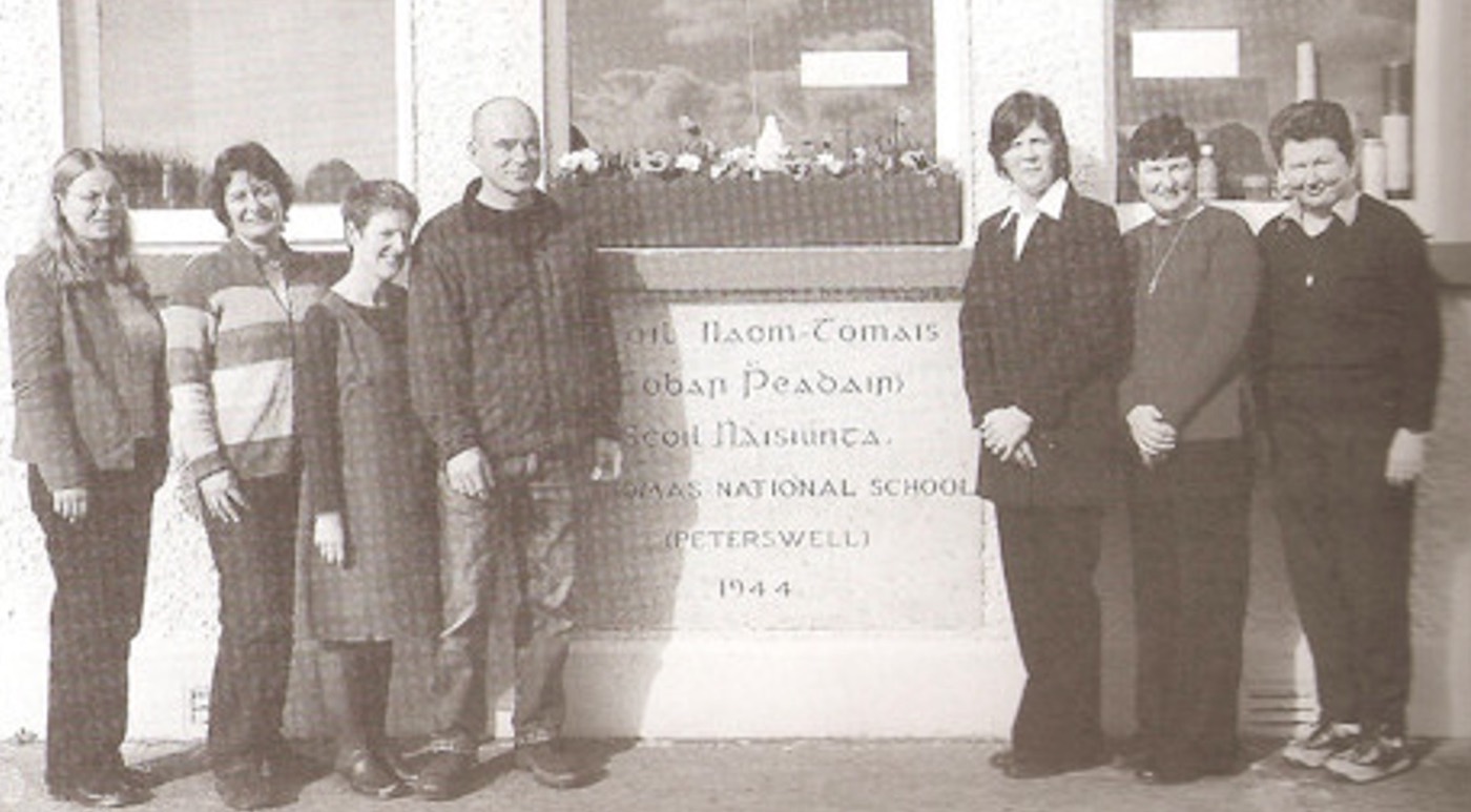 Staff outside St Thomas' National School beside the 1944 foundation plaque