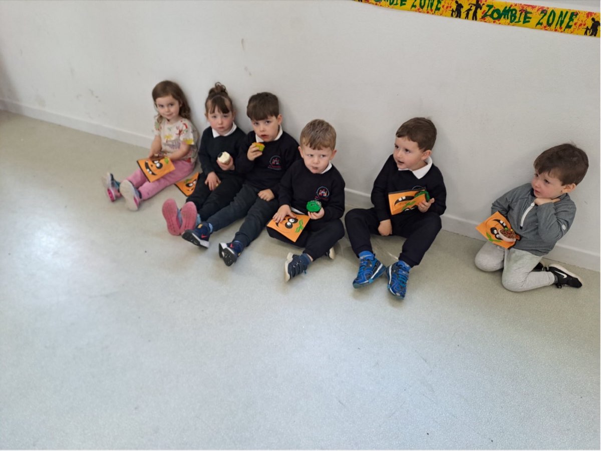 Pupils sitting together in the school hall