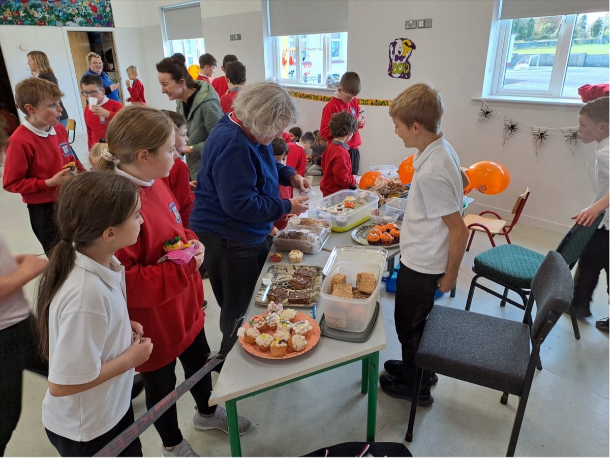 Pupils choosing cakes at the student council fundraiser