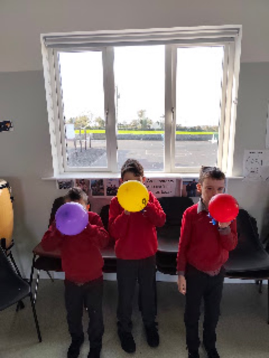 Pupils testing the balloon cars they built in the halla