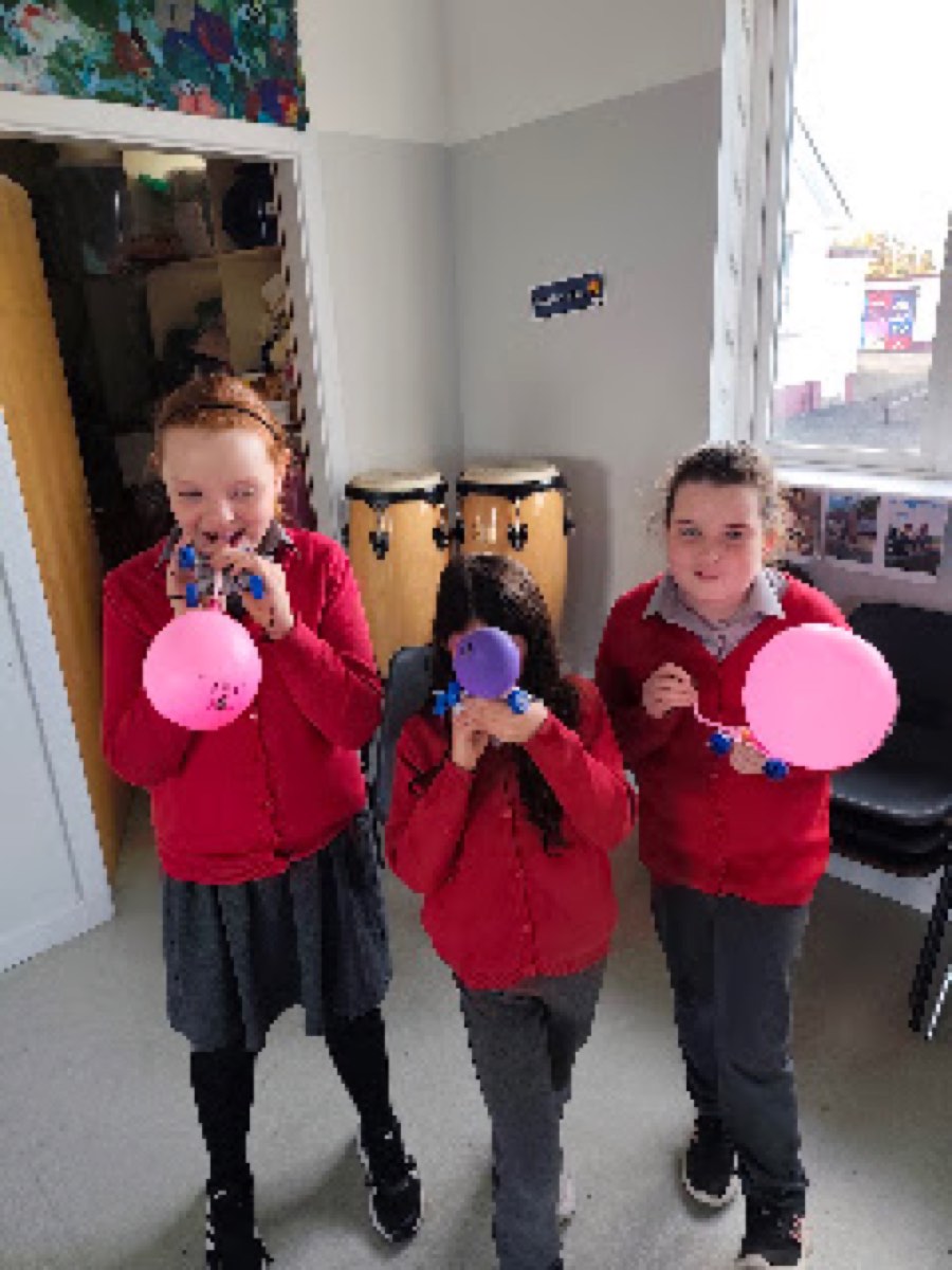 Pupils testing the balloon cars they built in the halla