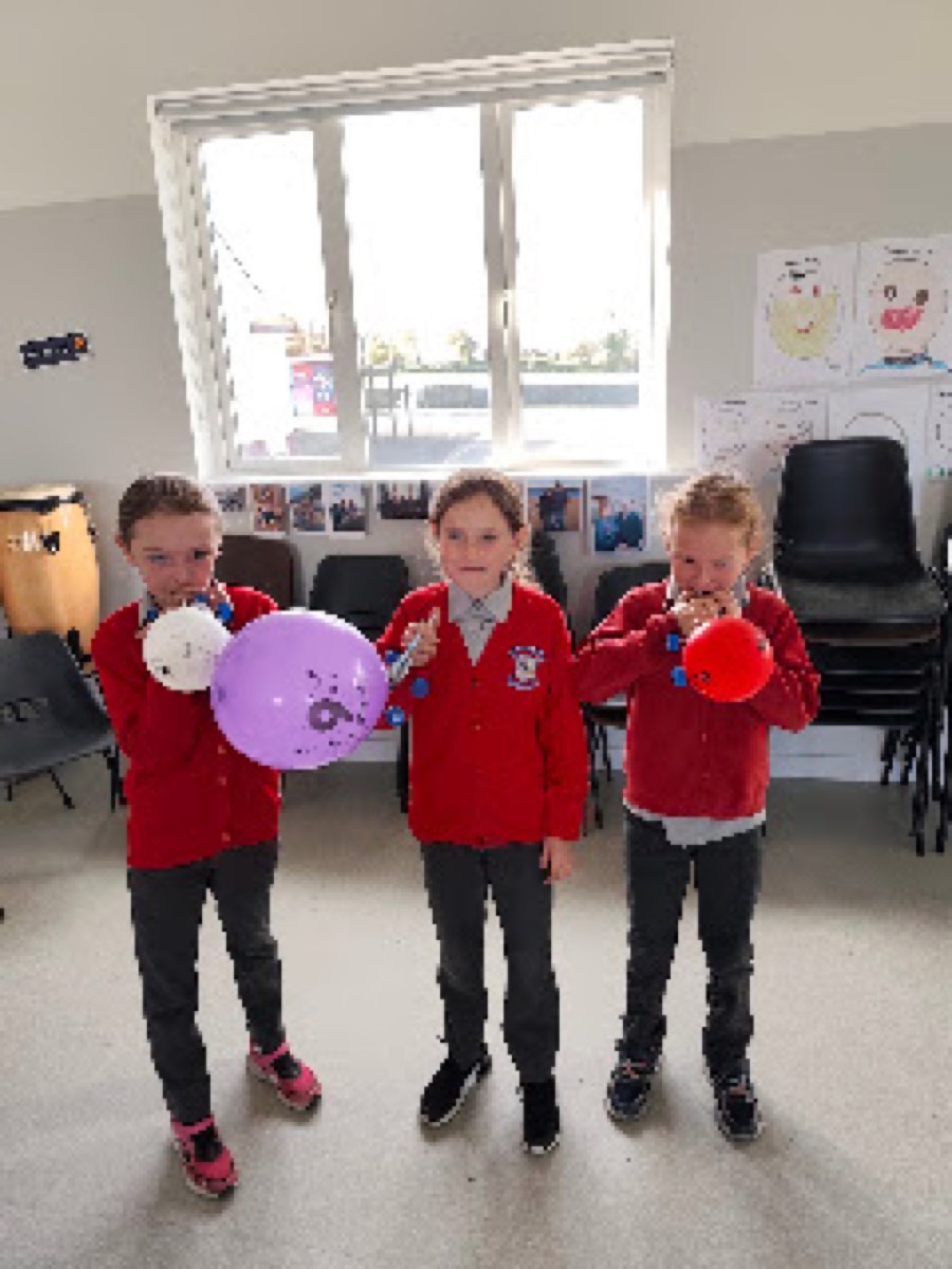 Pupils testing the balloon cars they built in the halla