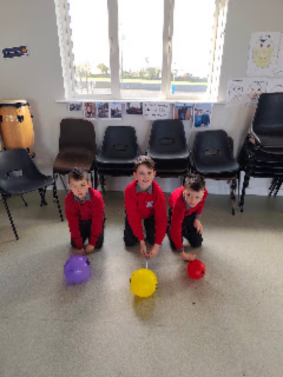Pupils testing the balloon cars they built in the halla