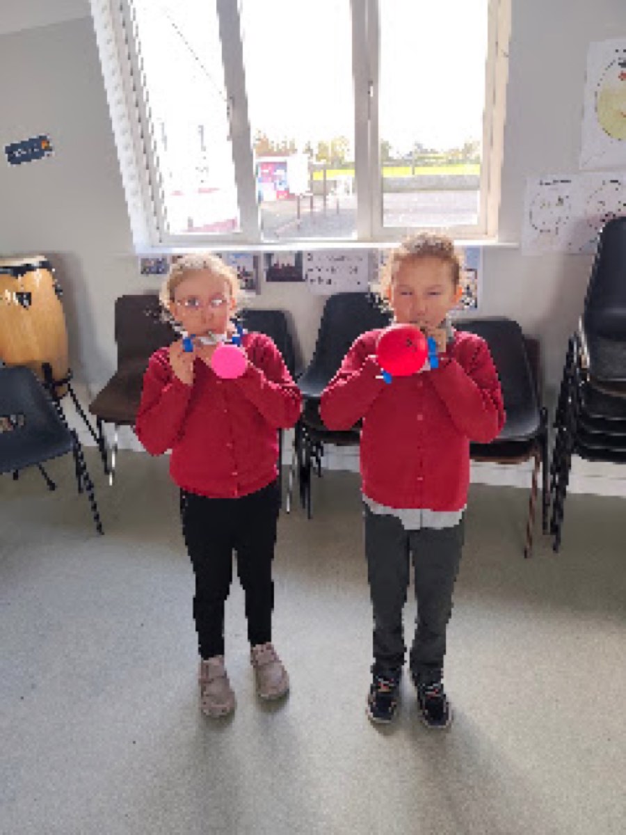 Pupils testing the balloon cars they built in the halla